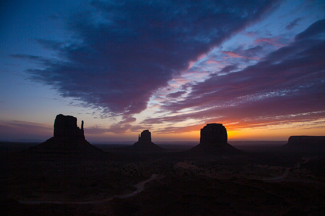 Colorful sunrise over the Mittens & Merrick Butte at dawn in the Monument Valley Navajo Tribal Park in Arizona.