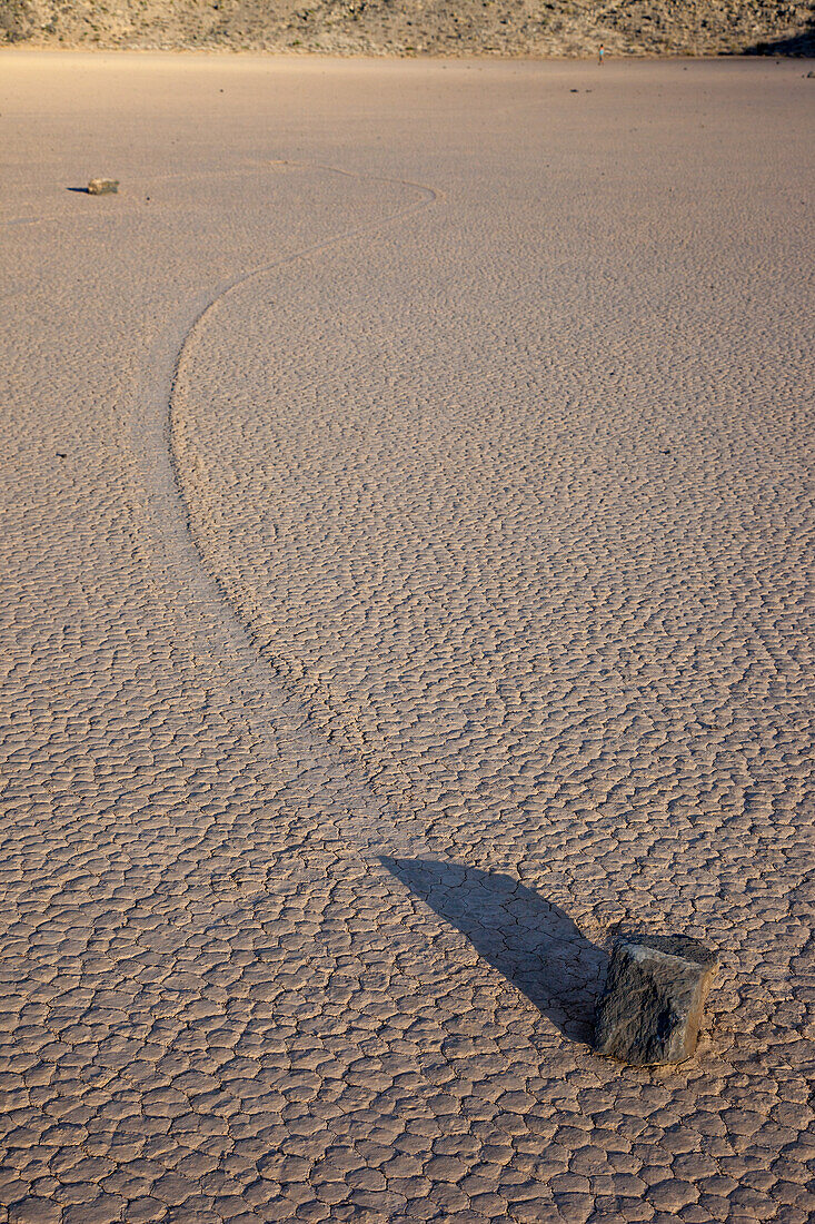 Sailing stone & track on the Racetrack Playa in Death Valley National Park in the Mojave Desert, California.