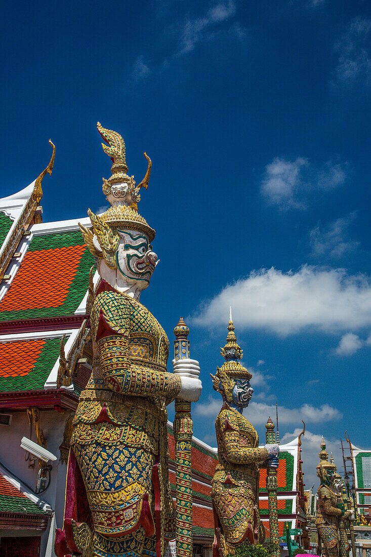 Yaksha guardian statues at the Temple of the Emerald Buddha complex in the Grand Palace grounds in Bangkok, Thailand. A yaksha or yak is a giant guardian spirit in Thai lore.