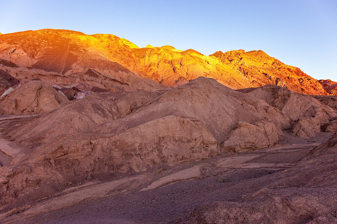 Colorful eroded badlands of the Artist's Palette at sunset in Death Valley National Park in California.