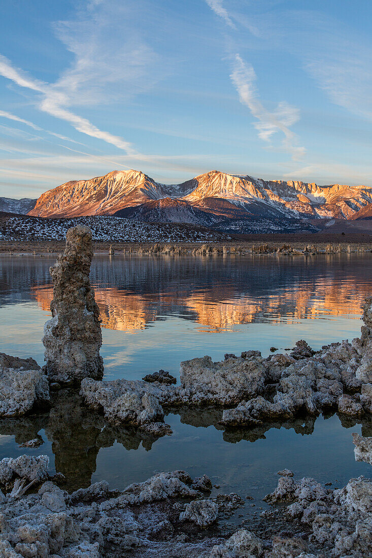 Tufa formations in Mono Lake in California at sunrise with the Eastern Sierra Mountains in the background.