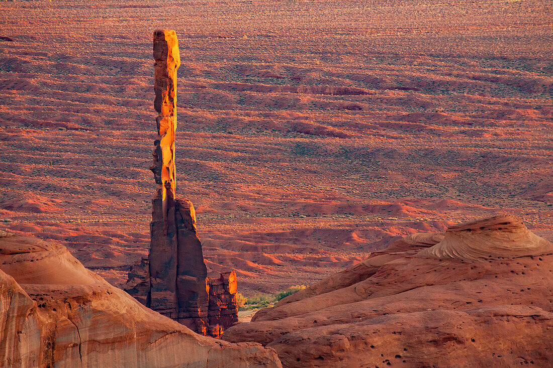 Telephoto view of the Totem Pole in Monument Valley from Hunt's Mesa in the Monument Valley Navajo Tribal Park in Arizona.
