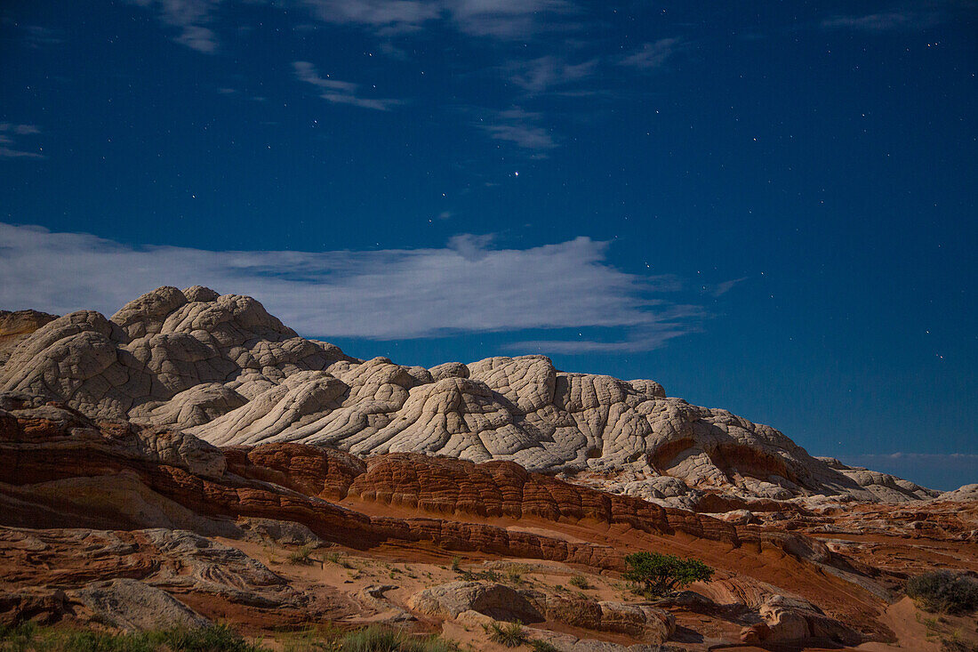 Stars over the colorful moonlit sandstone in the White Pocket Recreation Area, Vermilion Cliffs National Monument, Arizona.