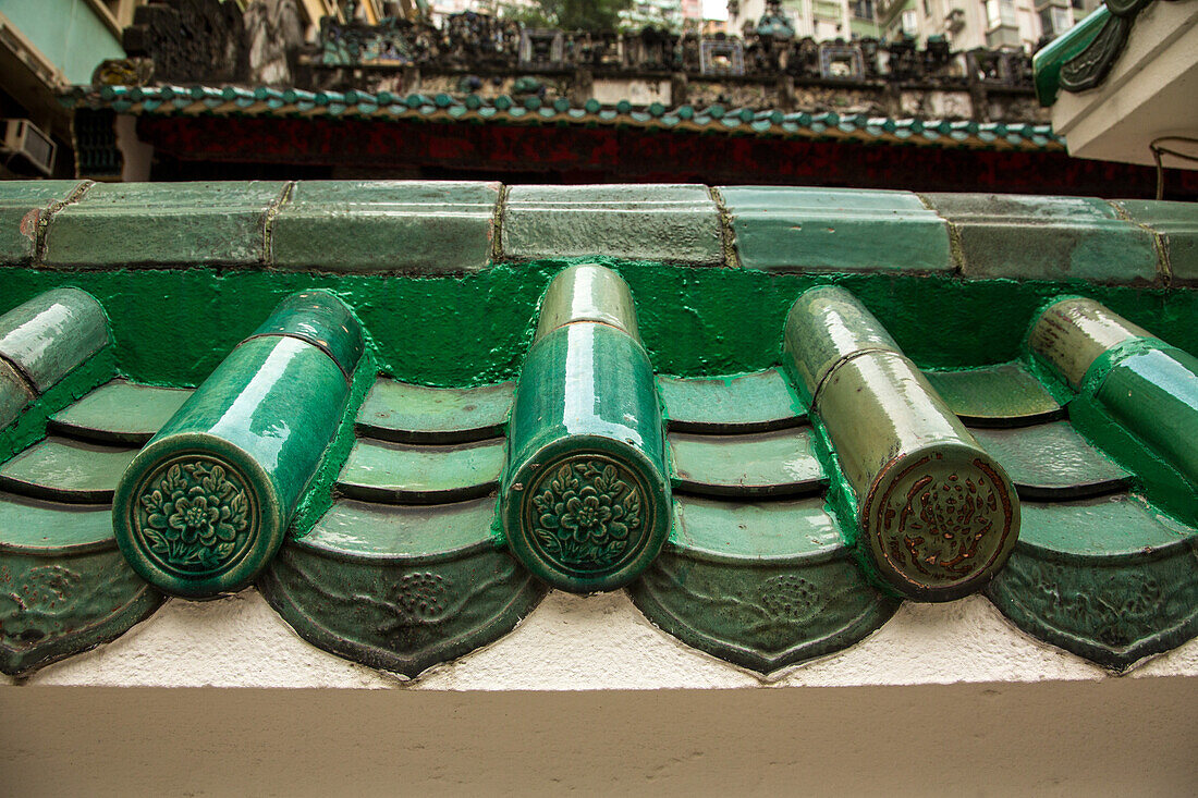 Glazed clay tiles characteristic of traditional Chinese architecture on the Man Mo Temple in Hong Kong.