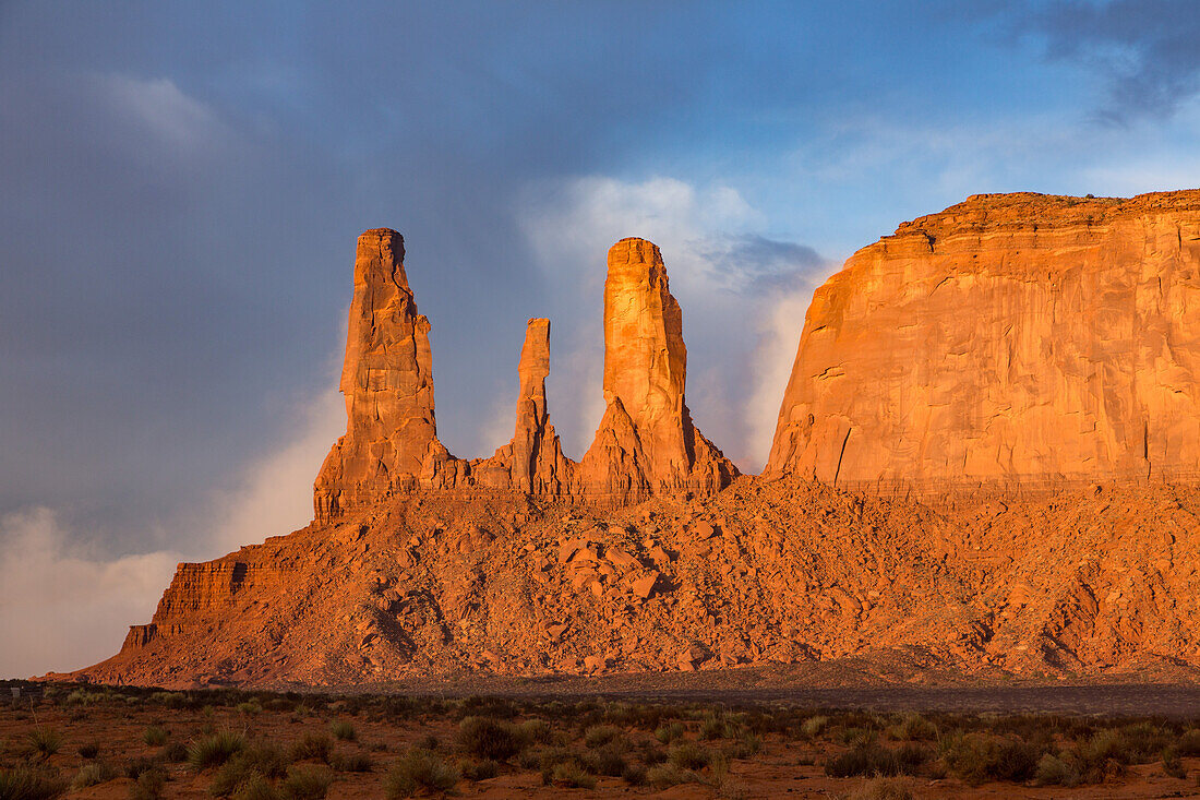The Three Sisters, sandstone monoliths at the edge of Mitchell Mesa in the Monument Valley Navajo Tribal Park in Arizona.