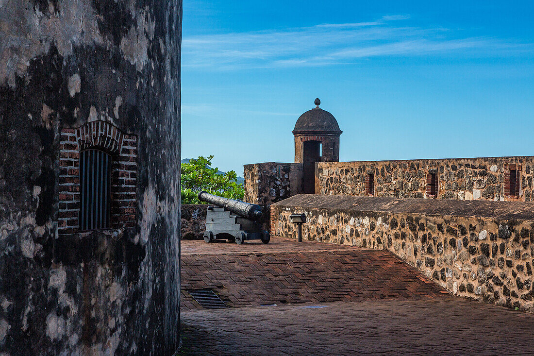 A Spanish cannon by a guerite or sentry box at Fortaleza San Felipe, now a museum at Puerto Plata, Dominican Republic.