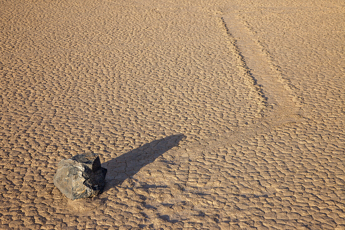 Sailing stone & track on the Racetrack Playa in Death Valley National Park in the Mojave Desert, California.