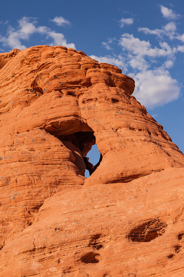 An unnamed natural arch in the eroded Aztec sandstone of Valley of Fire State Park in Nevada.