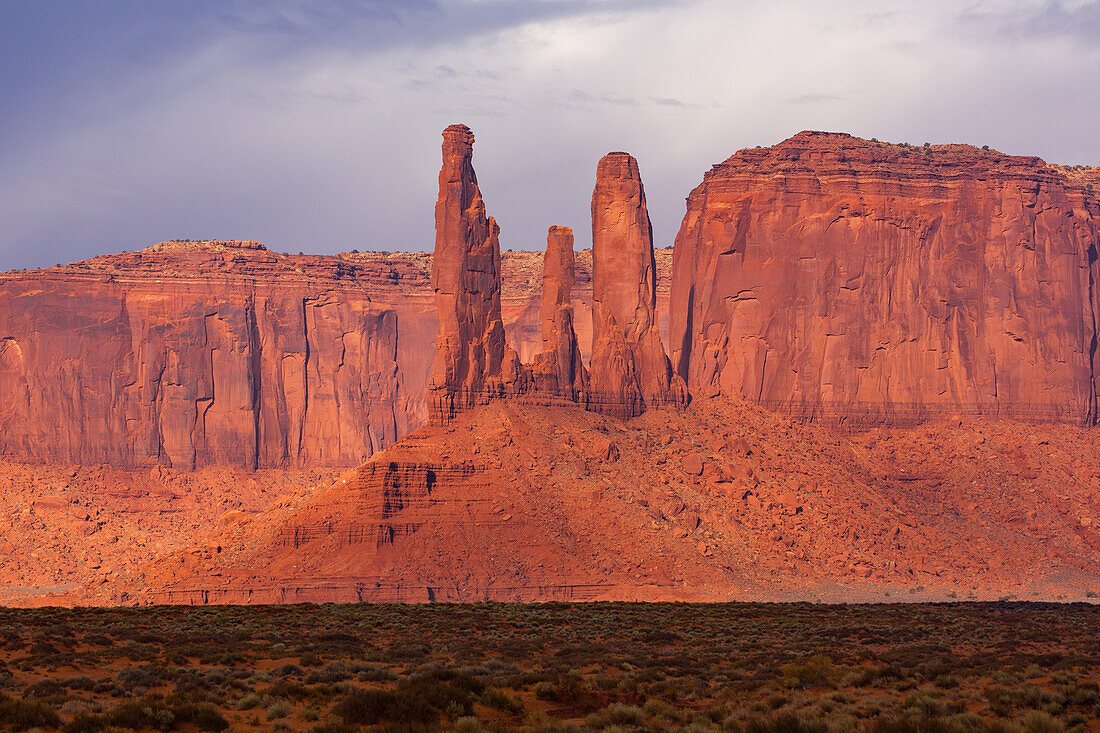 The Three Sisters, sandstone monoliths at the edge of Mitchell Mesa in the Monument Valley Navajo Tribal Park in Arizona.