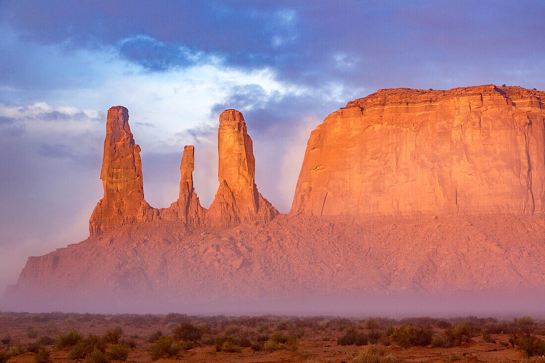 The Three Sisters, sandstone monoliths at the edge of Mitchell Mesa in the Monument Valley Navajo Tribal Park in Arizona.