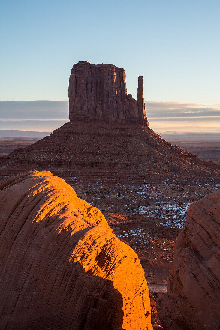 Sunrise on the boulders in front of the West Mitten Butte in the Monument Valley Navajo Tribal Park in Arizona