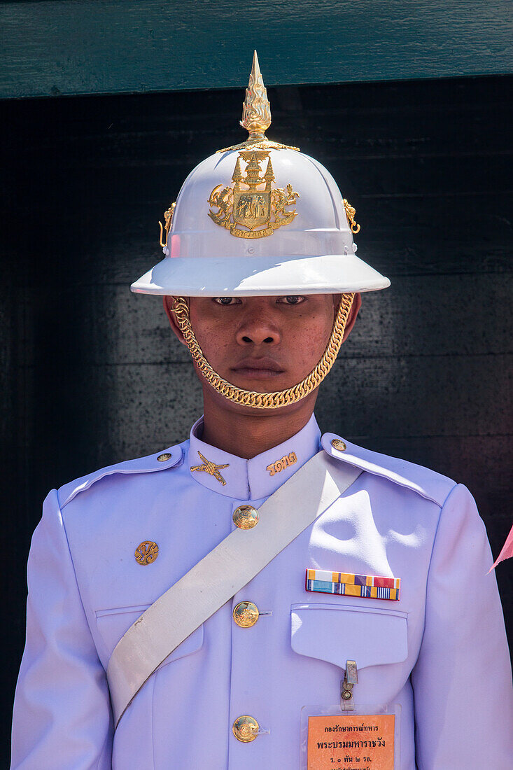 A Thai soldier in ceremonial uniform on duty at the Grand Palace complex in Bangkok, Thailand.