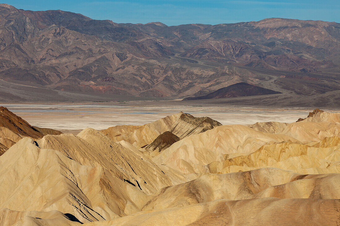 Eroded badlands of the Furnace Creek Formation at Zabriskie Point in Death Valley National Park in California. The Badwater Basin & Panamint Mountains arae behind.