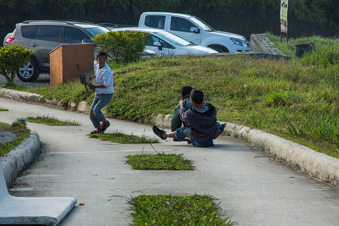 Dominican boys ride their homemade skateboard near Constanza in the Dominican Republic.