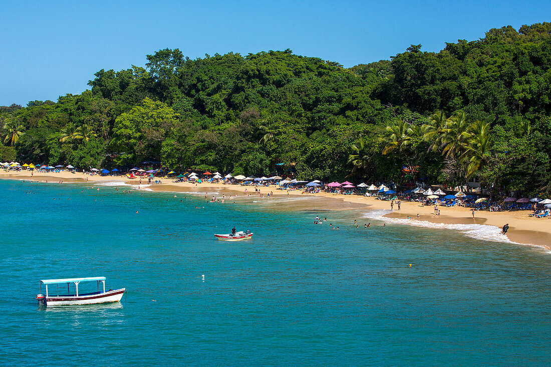 Tourists on the beach on Sosua Bay in the Dominican Republic.