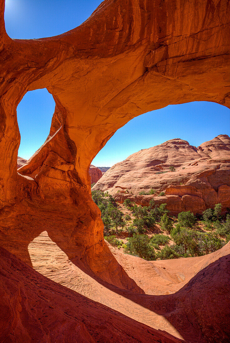 Spiderweb Arch, a large natural double arch in the Monument Valley Navajo Tribal Park in Arizona.