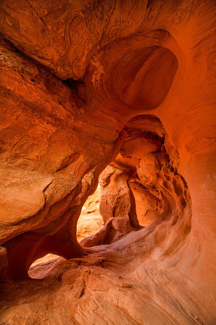 Three small arches in the colorful eroded Aztec sandstone of the Fire Cave in Valley of Fire State Park in Nevada.