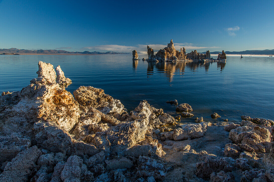 Tufa formations in Mono Lake in California at sunrise with fog in the background.