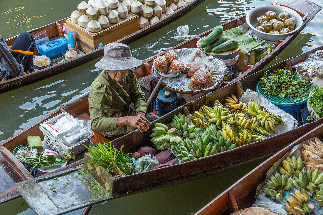 Thai vendors on their boats in the Damnoen Saduak Floating Market in Thailand.