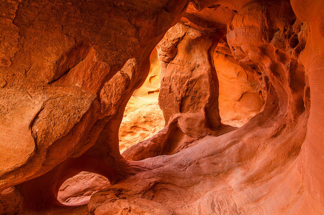 Three small arches in the colorful eroded Aztec sandstone of the Fire Cave in Valley of Fire State Park in Nevada.
