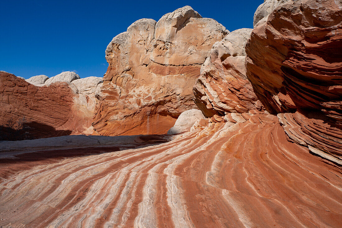 Eroded Navajo sandstone formations in the White Pocket Recreation Area, Vermilion Cliffs National Monument, Arizona. Small laterally displaced faults are evident in the stripes.