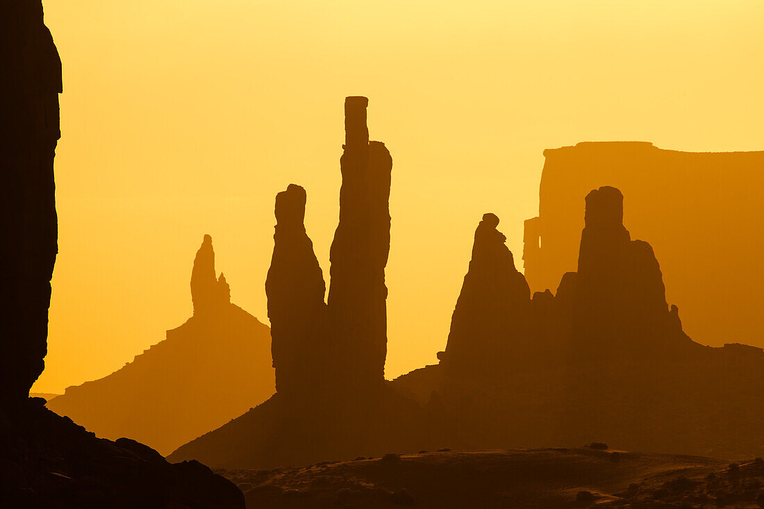 Telephoto view of the Totem Pole, Yei Bi Chei & Rooster Rock / Butte in the Monument Valley Navajo Tribal Park in Arizona.