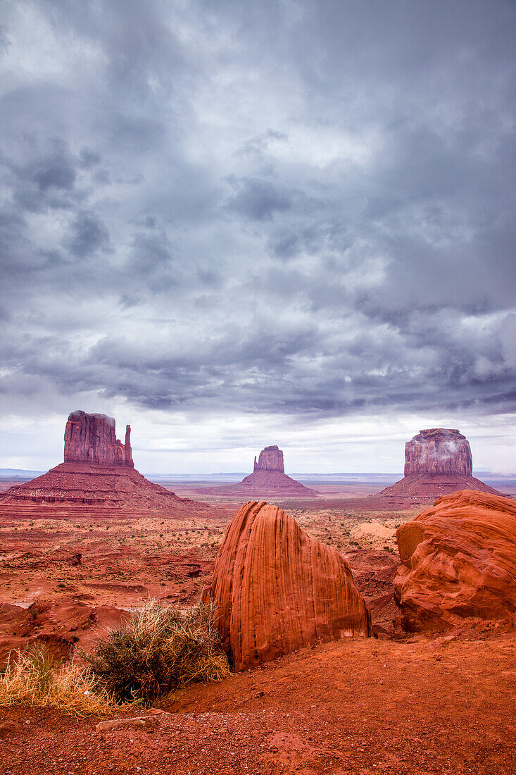 Stormy skies over the Mittens and Merrick Butte in the Monument Valley Navajo Tribal Park in Arizona.