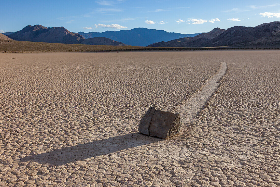 Sailing stone & track on the Racetrack Playa in Death Valley National Park in the Mojave Desert, California.