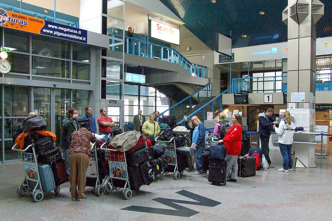 Passengers and baggage in the older Vilnius International Airport terminal in Lithuania.