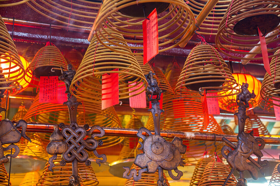 Burning incense coils send prayers to heaven in the Man Mo Temple, a Buddhist temple in Hong Kong, China.