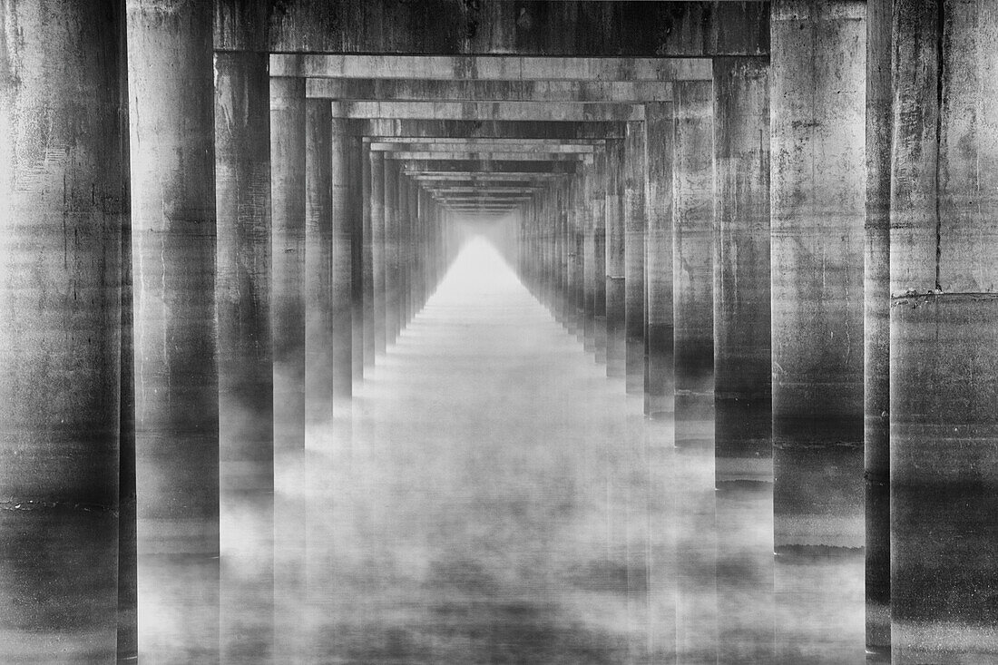 Morning fog under the Interstate 10 highway bridge over the Atchafalaya River in the Atchafalaya Basin in Louisiana.