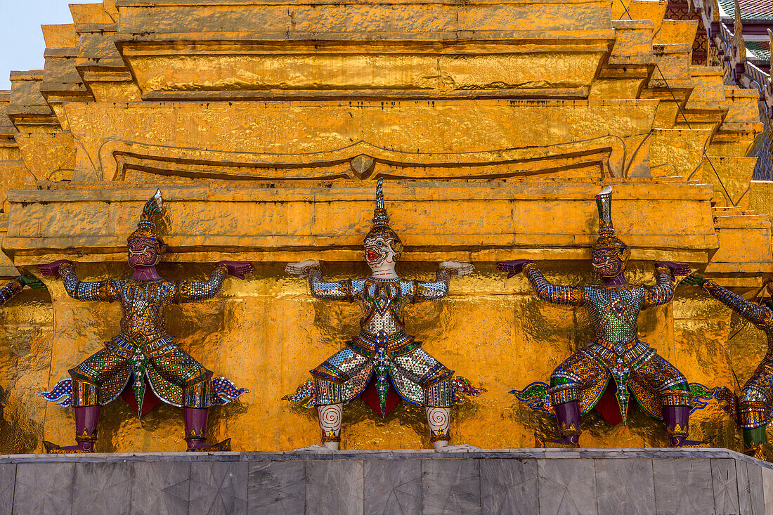 Small yaksha guardian statues at the Temple of the Emerald Buddha complex in the Grand Palace grounds in Bangkok, Thailand. A yaksha or yak is a giant guardian spirit in Thai lore.