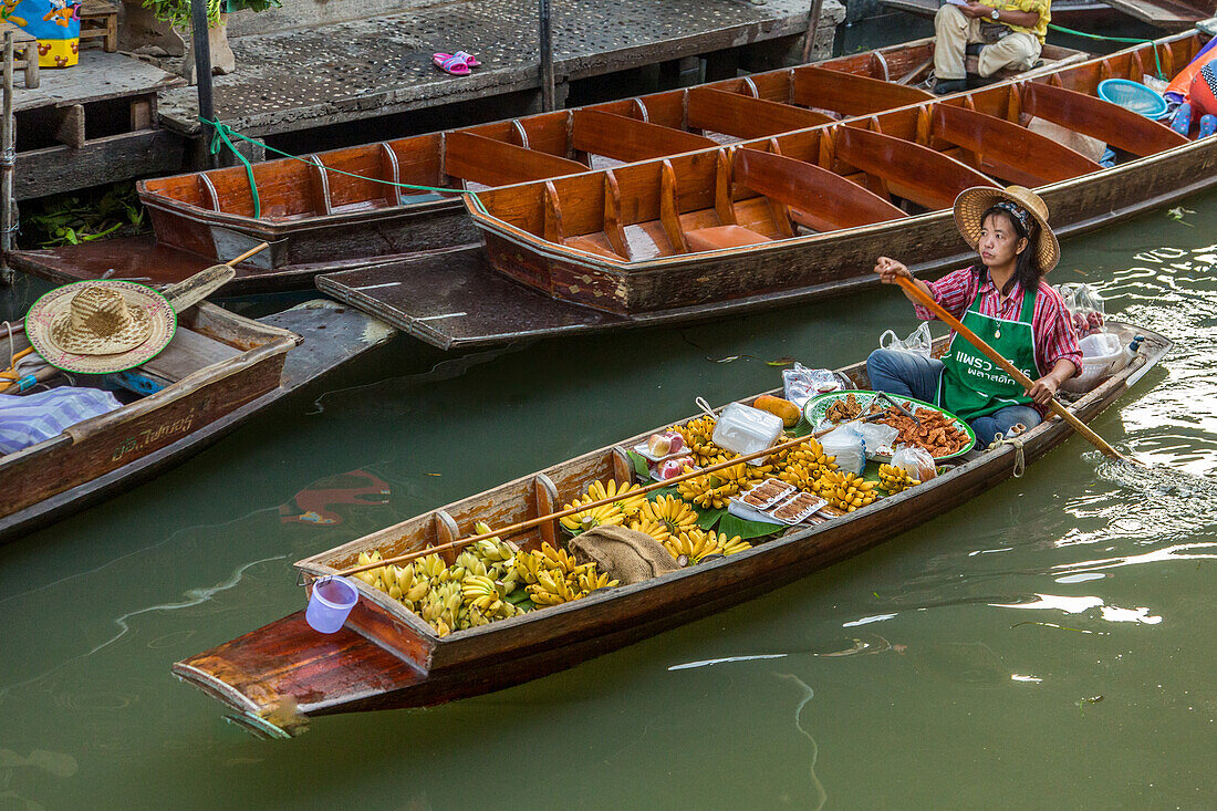 Thai vendors on their boats in the Damnoen Saduak Floating Market in Thailand.