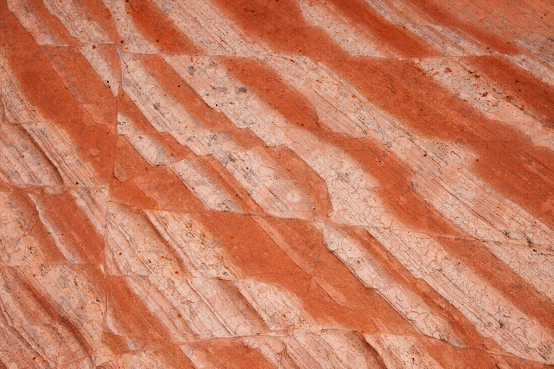 Eroded Navajo sandstone formations in the White Pocket Recreation Area, Vermilion Cliffs National Monument, Arizona. Small laterally displaced faults are evident in the stripes.