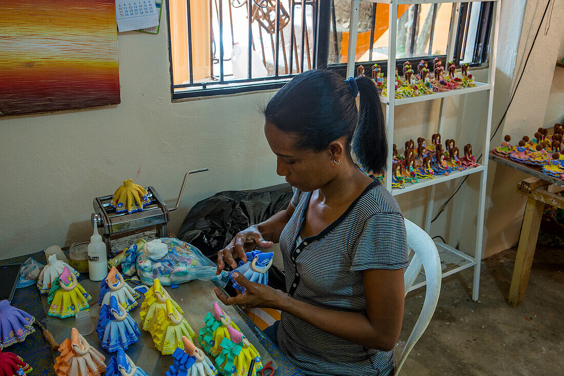 A worker making Dominican faceless dolls in a home workshop in the Dominican Republic. The faceless dolls represent the ethnic diversity of the Dominican Republic.