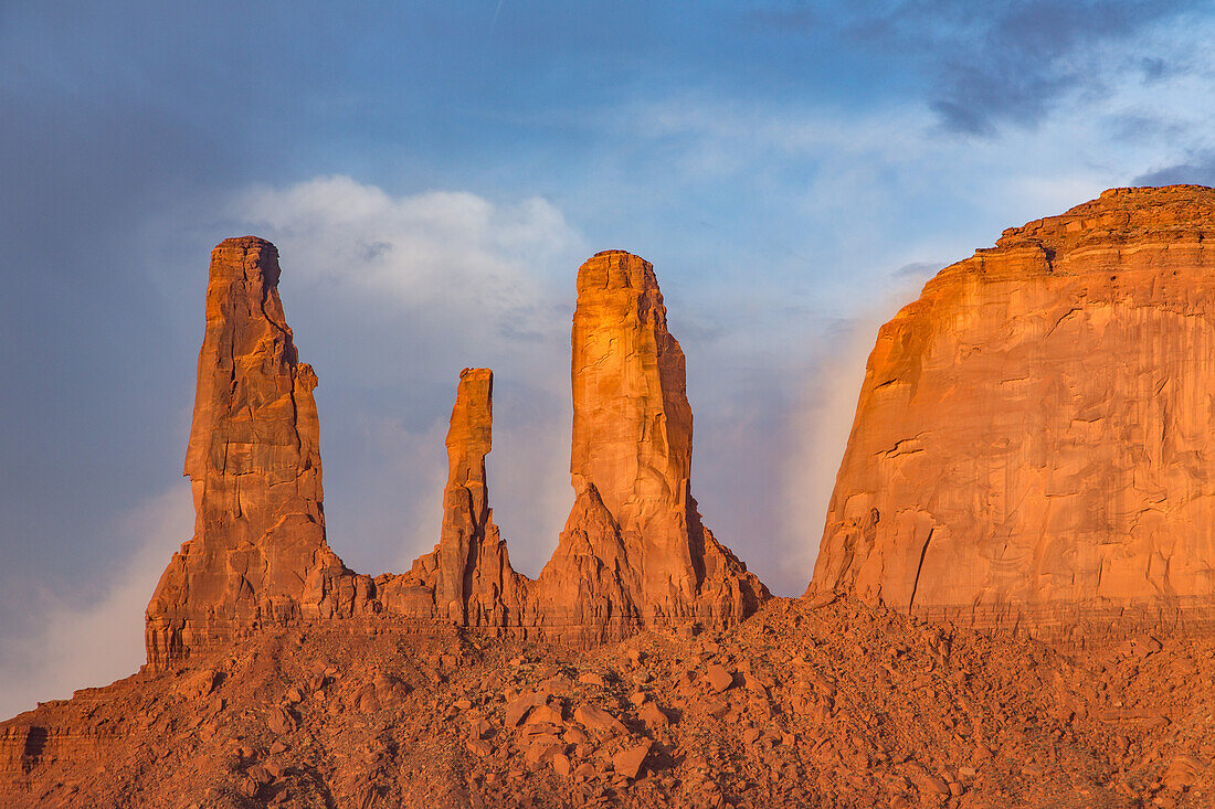 The Three Sisters, sandstone monoliths at the edge of Mitchell Mesa in the Monument Valley Navajo Tribal Park in Arizona.