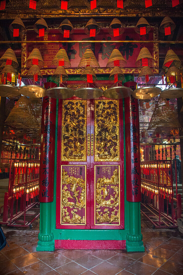 The doorway with gilded dragons at the entrance to the Buddhist Man Mo Temple in Hong Kong, China.