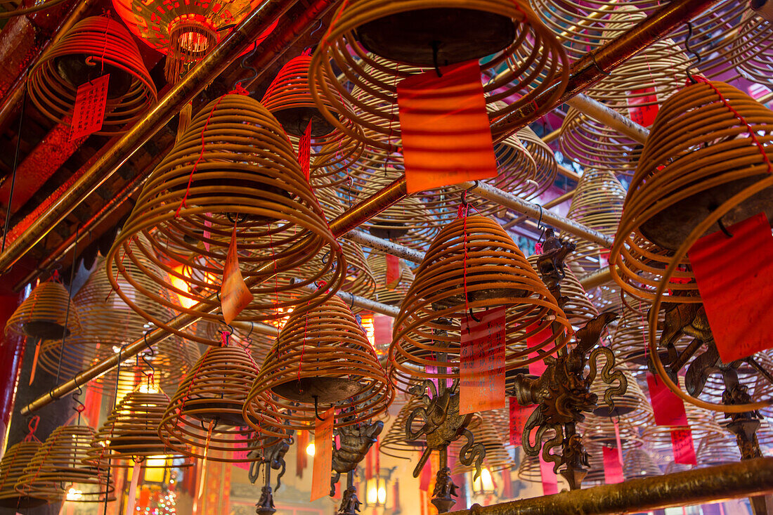 Burning incense coils send prayers to heaven in the Man Mo Temple, a Buddhist temple in Hong Kong, China.