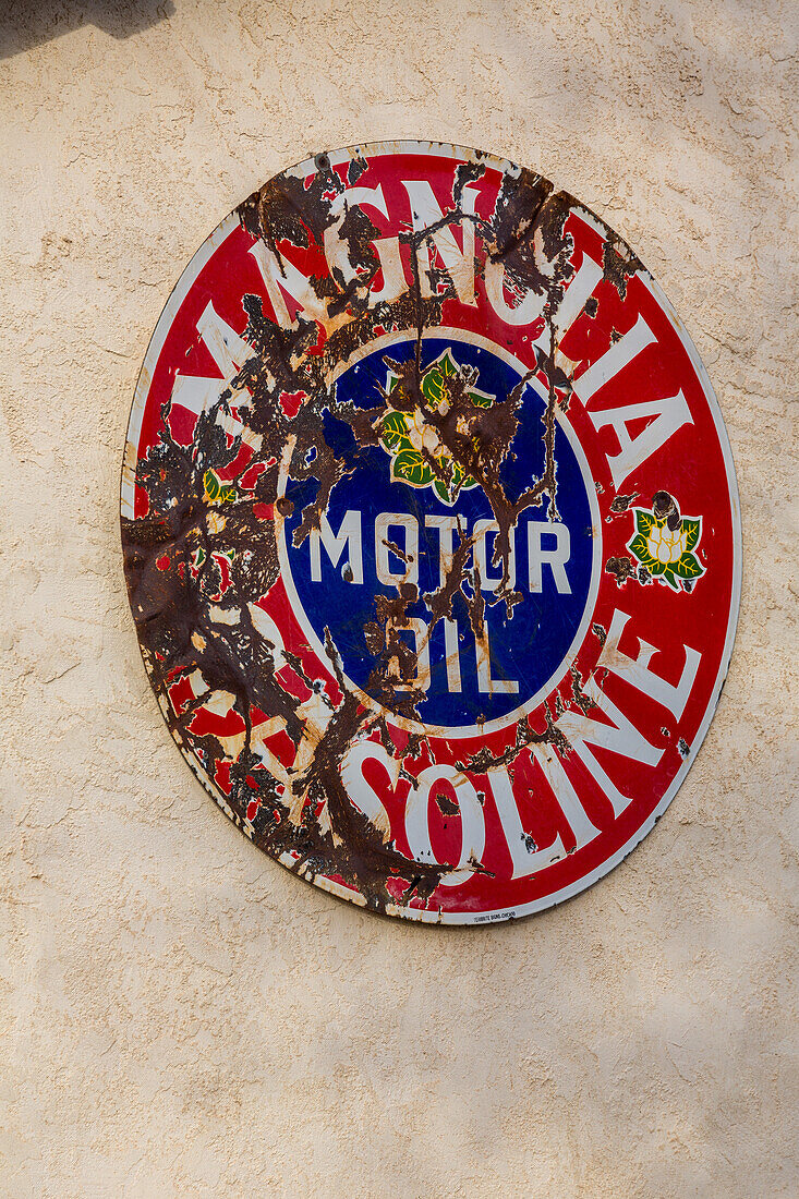 A vintage sign for Magnolia gasoline & motor oil on a building in San Antonio, a small town in rural New Mexico.