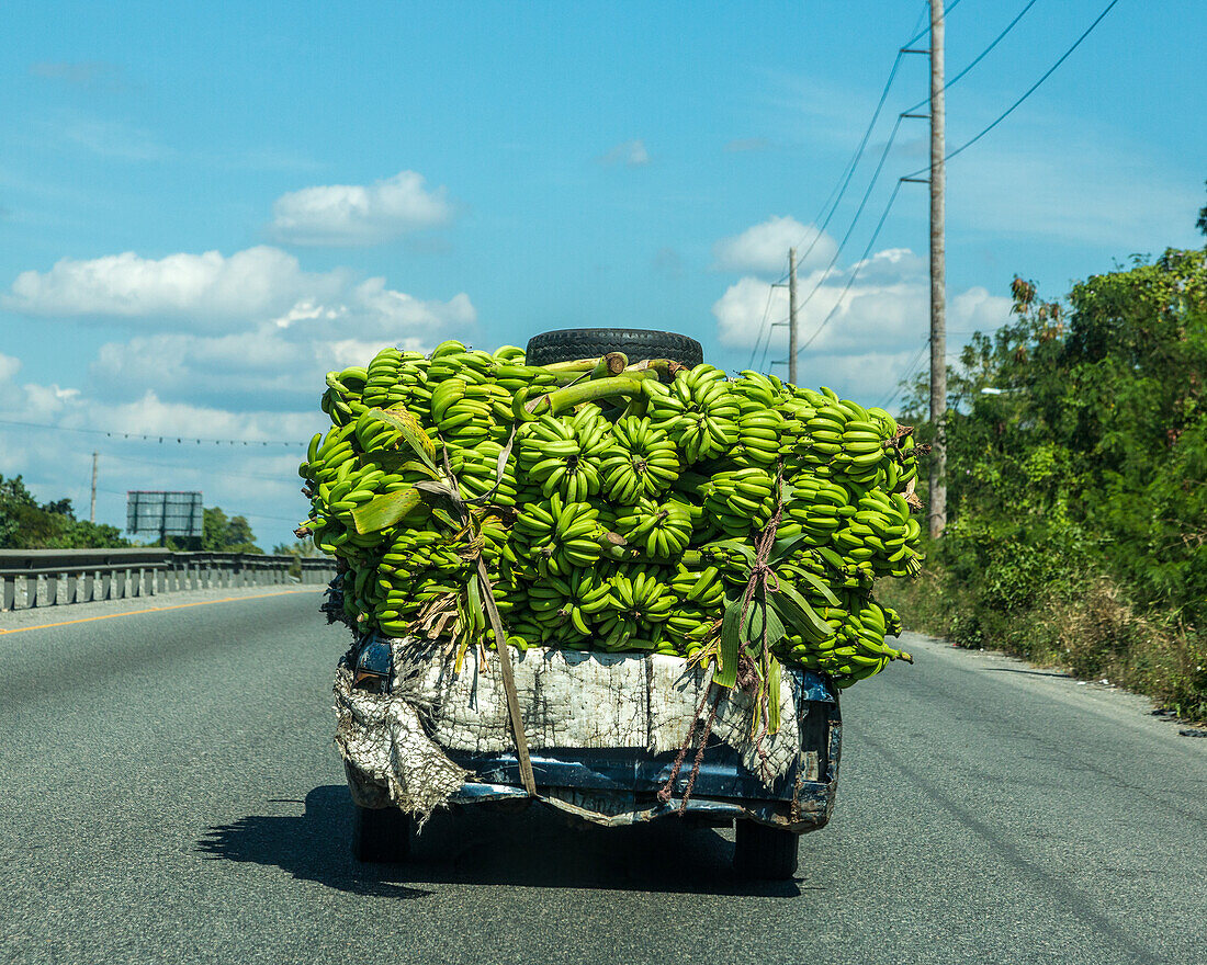 An old, overloaded banana truck on the highway near Bani in the Dominican Republic.