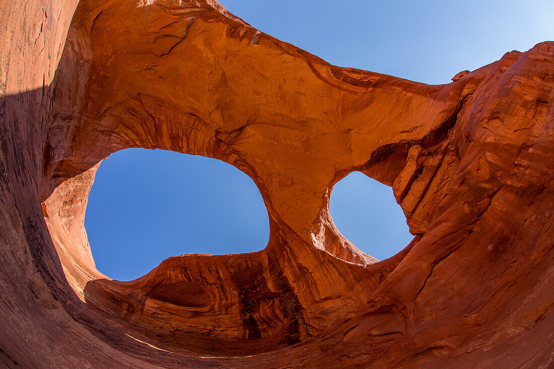 Spiderweb Arch, a large natural double arch in the Monument Valley Navajo Tribal Park in Arizona.