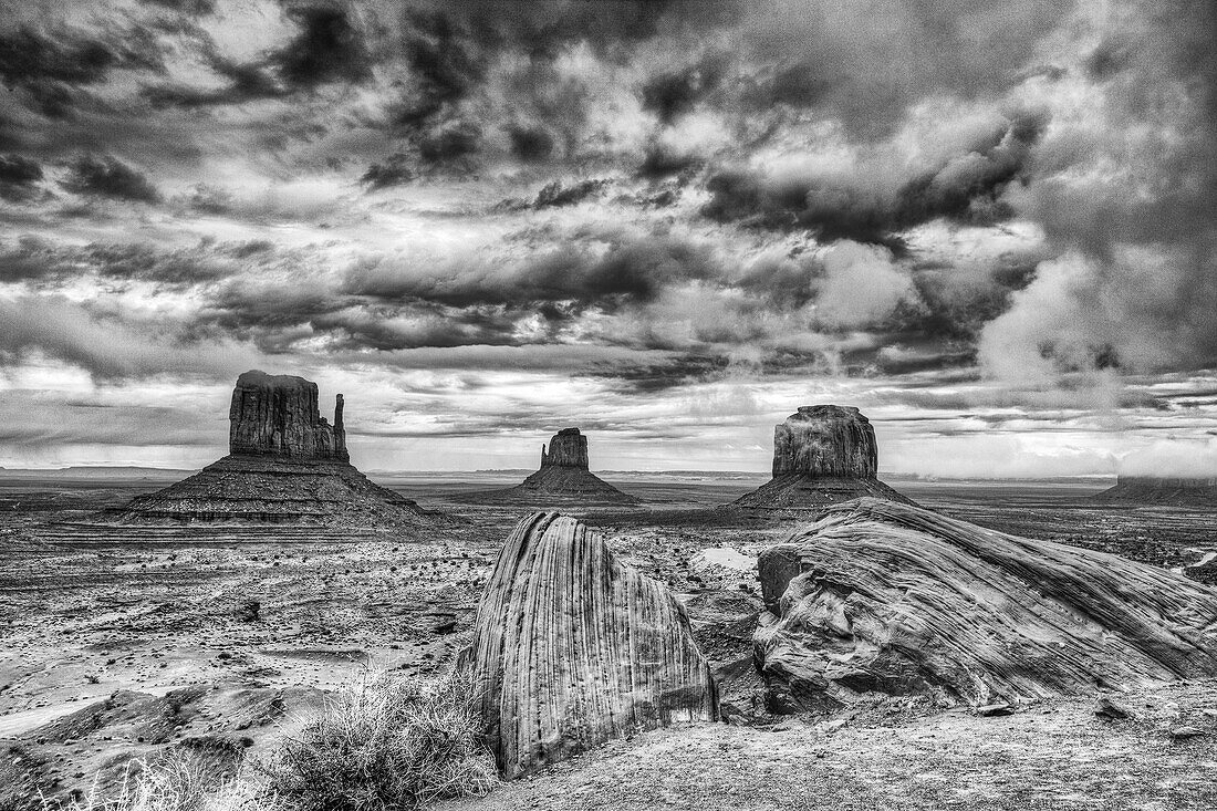 Stormy skies over the Mittens and Merrick Butte in the Monument Valley Navajo Tribal Park in Arizona.