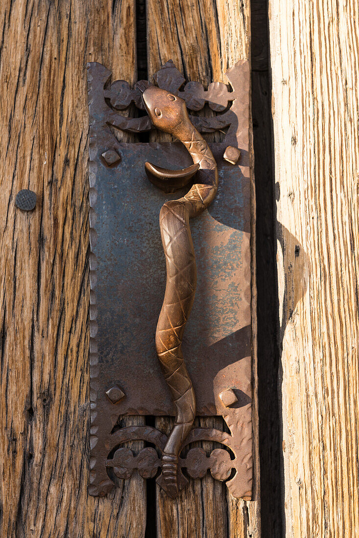 Detail of the cast iron serpent on the door handle of the entry door in the Mission San Xavier del Bac, Tucson Arizona.