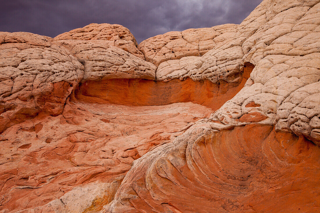 Stormy clouds over colorful eroded sandstone formations. White Pocket Recreation Area, Vermilion Cliffs National Monument, Arizona.