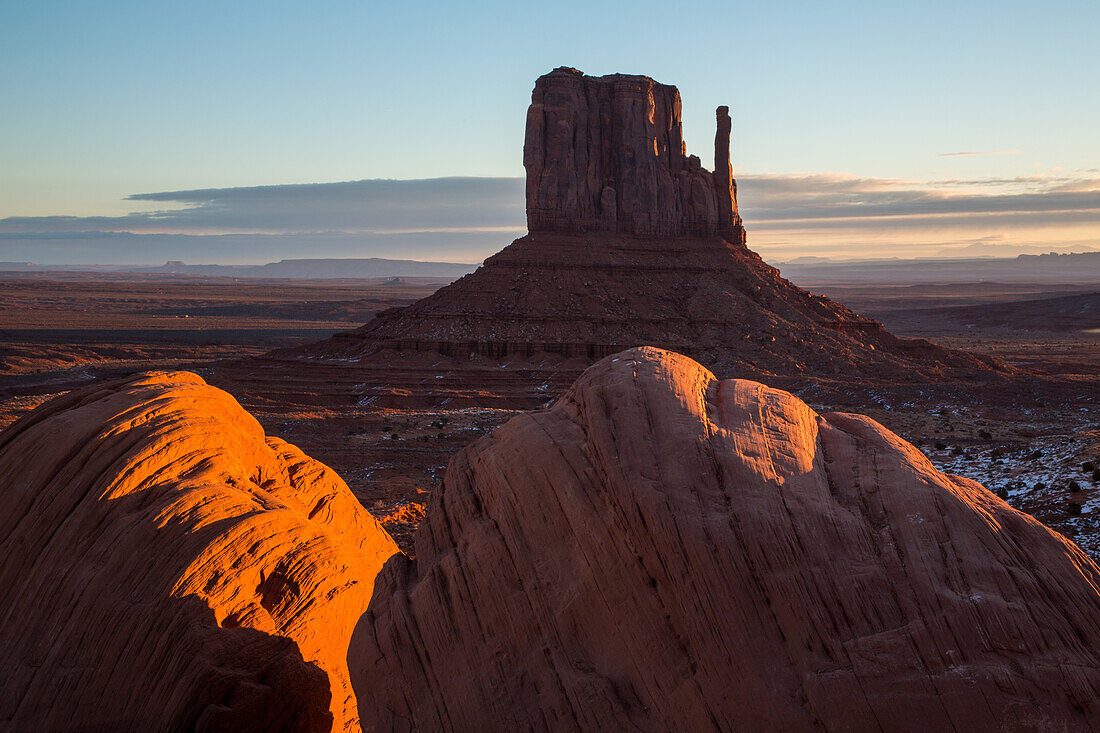 Sunrise on the boulders in front of the West Mitten Butte in the Monument Valley Navajo Tribal Park in Arizona