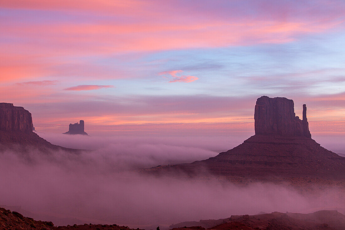 Colorful sunrise with ground fog in the Monument Valley Navajo Tribal Park in Arizona.