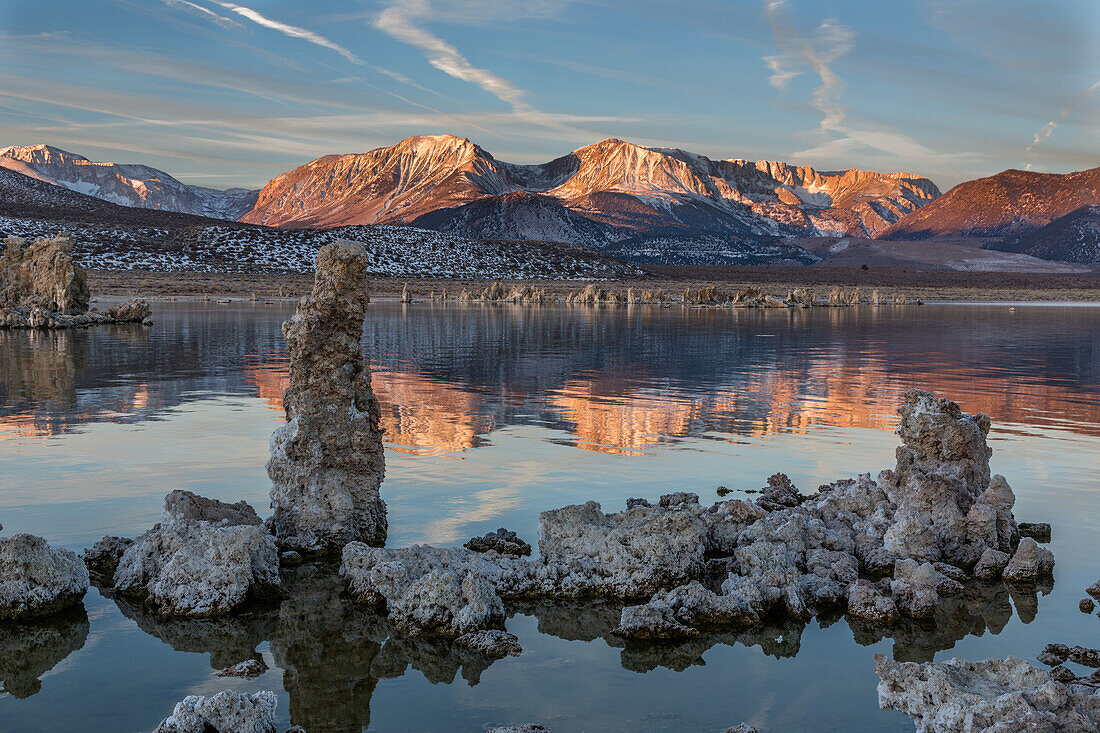 Tufa formations in Mono Lake in California at sunrise with the Eastern Sierra Mountains in the background.