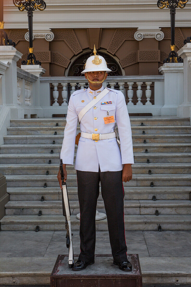 A Thai soldier in ceremonial uniform on duty at the Grand Palace complex in Bangkok, Thailand.