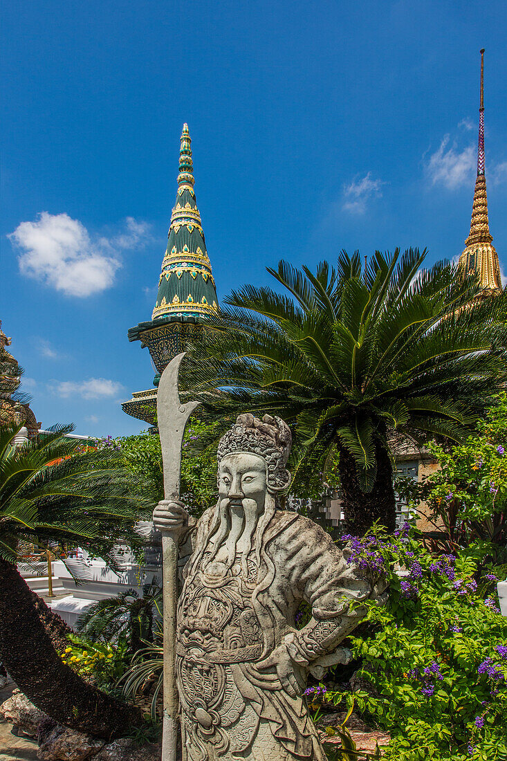 Carved stone statue of a Chinese guardian in the Grand Palace complex in Bangkok, Thailand.