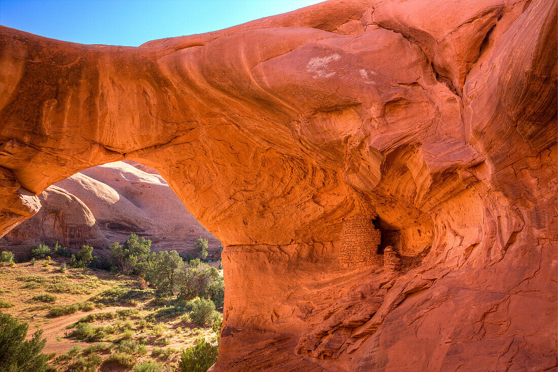 An Ancestral Puebloan ruin inside Honeymoon Arch in Mystery Valley in the Monument Valley Navajo Tribal Park in Arizona.